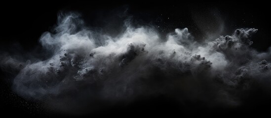 Obraz premium Abstract real dust floating over black background.