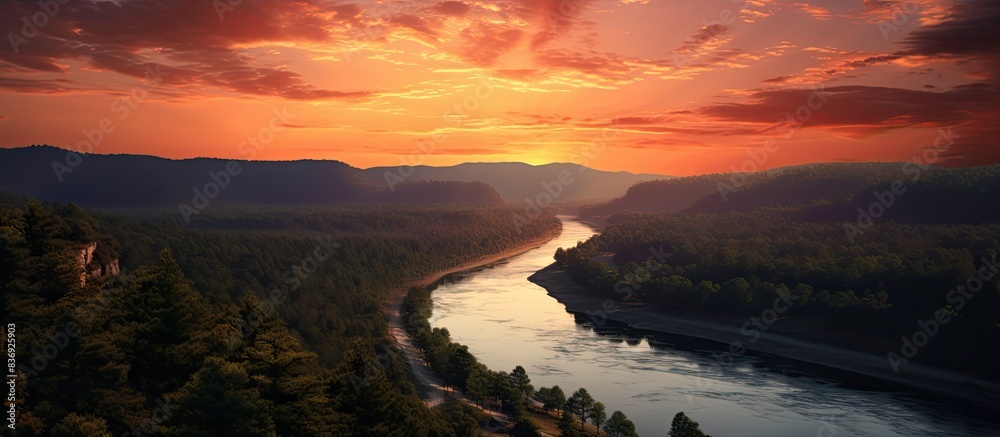 Poster scenic view overlooking a river, forest, and sunset with a red sky from a cliff with a mesmerizing l