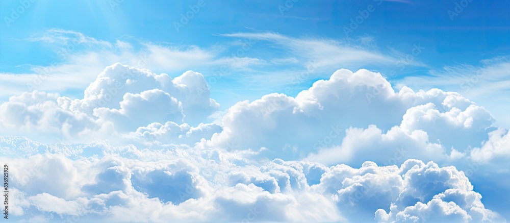 Poster the blue sky with fluffy white clouds provides a serene backdrop for the copy space image.