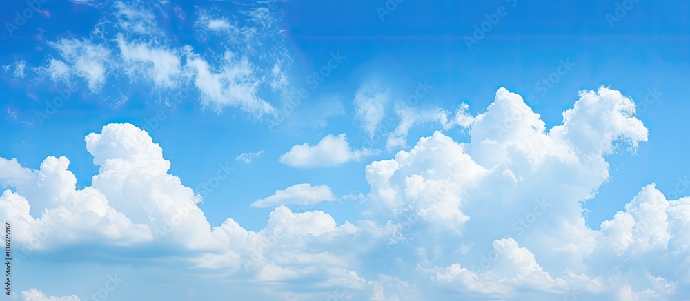 Aufkleber Blue sky with fluffy clouds creating a serene atmosphere with ample copy space image.