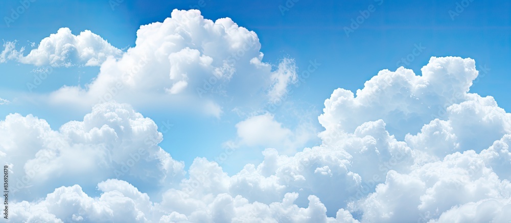 Poster Sky background with fluffy clouds providing copy space image.
