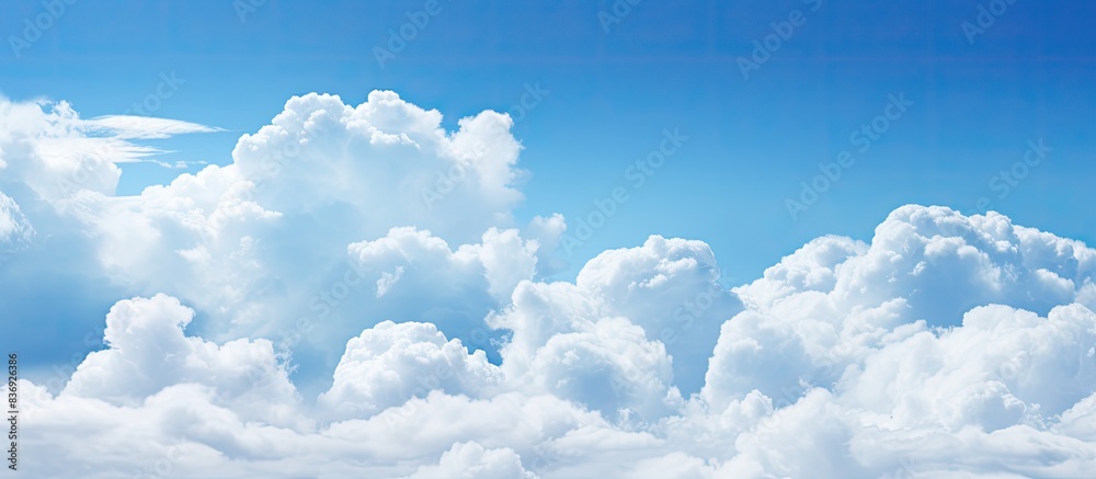 Poster Cloudy weather with cumulus clouds creates an abstract backdrop suitable for design projects with copy space image.