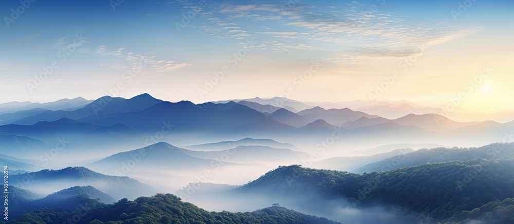 Poster scenic sunrise over mountains with morning mist, creating a captivating landscape with a scenic copy