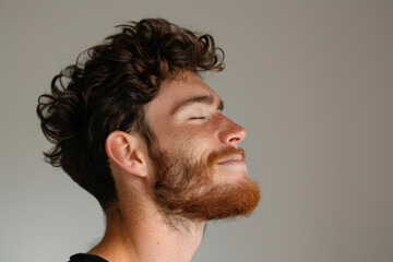 Fototapeta premium A close up of a man with beard and closed eyes looking to a side