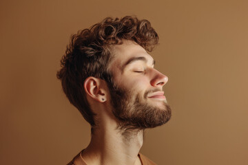 Fototapeta premium A close up of a man with beard and closed eyes looking to a side