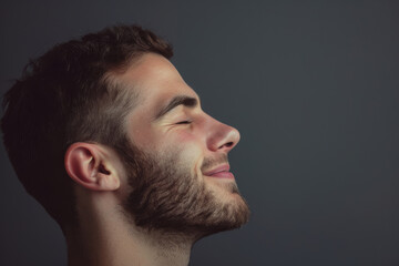 Fototapeta premium A close up of a man with beard and closed eyes looking to a side