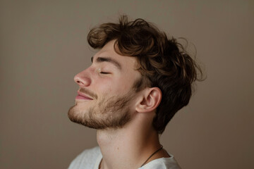 Fototapeta premium A close up of a man with beard and closed eyes looking to a side