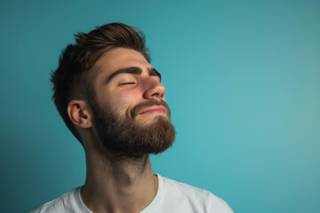 Fototapeta premium A close up of a man with beard and closed eyes looking to a side