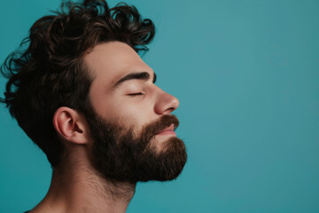 Fototapeta premium A close up of a man with beard and closed eyes looking to a side