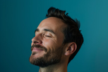 Obraz premium A close up of a man with beard and closed eyes looking to a side