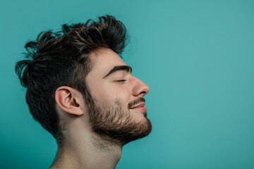 Fototapeta premium A close up of a man with beard and closed eyes looking to a side