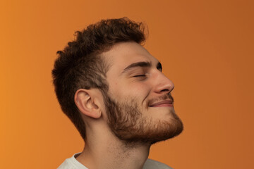 Obraz premium A close up of a man with beard and closed eyes looking to a side