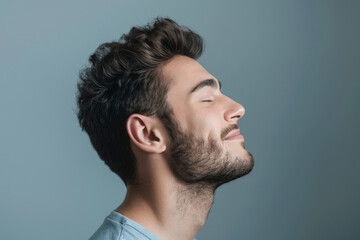 Obraz premium A close up of a man with beard and closed eyes looking to a side