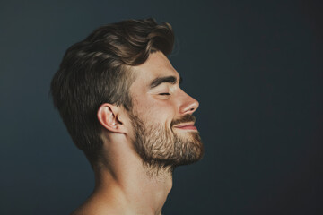 Fototapeta premium A close up of a man with beard and closed eyes looking to a side