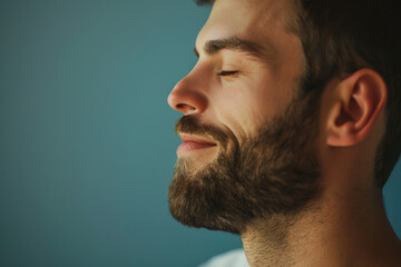 Fototapeta premium A close up of a man with beard and closed eyes looking to a side