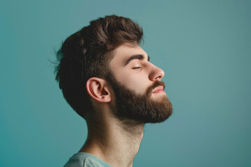 Obraz premium A close up of a man with beard and closed eyes looking to a side