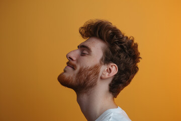 Fototapeta premium A close up of a man with beard and closed eyes looking to a side