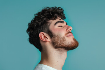 Obraz premium A close up of a man with beard and closed eyes looking to a side