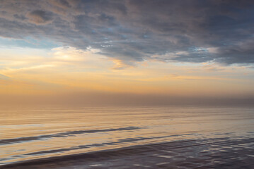 Baltic sea covered with fog after rain during the sunset at summer