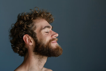 Fototapeta premium A close up of a man with beard and closed eyes looking to a side