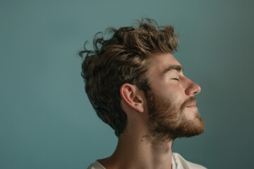Obraz premium A close up of a man with beard and closed eyes looking to a side