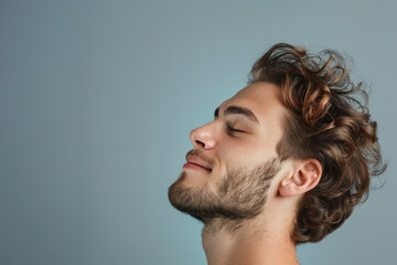 Fototapeta premium A close up of a man with beard and closed eyes looking to a side
