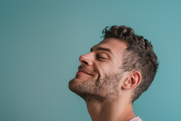 Obraz premium A close up of a man with beard and closed eyes looking to a side