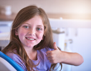 Dentist, child or portrait with thumbs up for teeth cleaning or cavity treatment for oral hygiene...