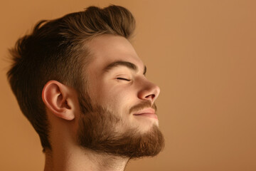 Fototapeta premium A close up of a man with beard and closed eyes looking to a side