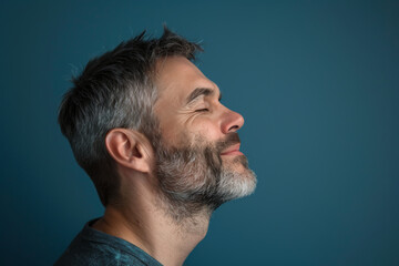 Obraz premium A close up of a man with beard and closed eyes looking to a side