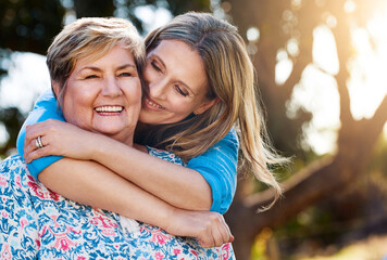 Happy, smile and woman hugging her senior mother in nature at an outdoor park in summer. Lady, love...