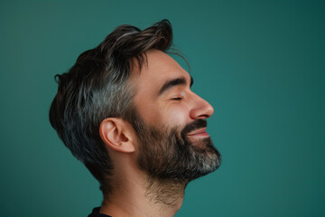 Fototapeta premium A close up of a man with beard and closed eyes looking to a side