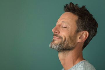 Obraz premium A close up of a man with beard and closed eyes looking to a side