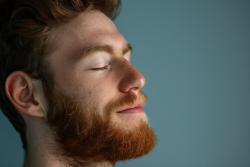 Fototapeta premium A close up of a man with beard and closed eyes looking to a side