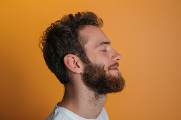 Obraz premium A close up of a man with beard and closed eyes looking to a side