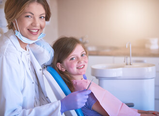 Dentist, happy kid and portrait with doctor for teeth cleaning or cavity treatment for oral hygiene...