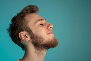 Fototapeta premium A close up of a man with beard and closed eyes looking to a side