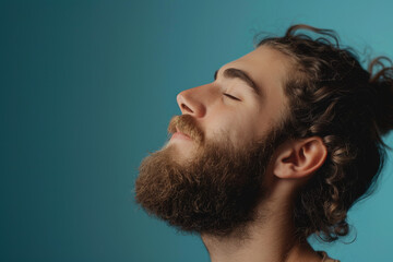 Fototapeta premium A close up of a man with beard and closed eyes looking to a side