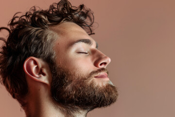 Fototapeta premium A close up of a man with beard and closed eyes looking to a side