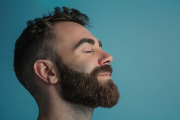 Fototapeta premium A close up of a man with beard and closed eyes looking to a side