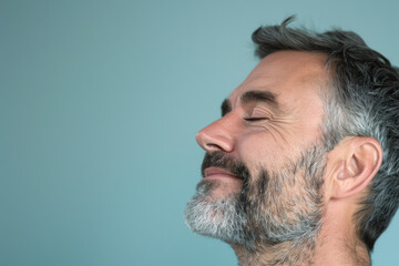 Fototapeta premium A close up of a man with beard and closed eyes looking to a side