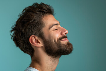 Fototapeta premium A close up of a man with beard and closed eyes looking to a side