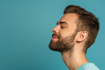 Fototapeta premium A close up of a man with beard and closed eyes looking to a side