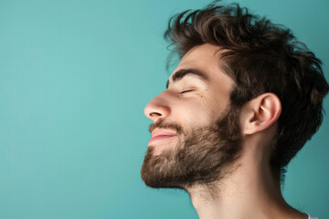 Fototapeta premium A close up of a man with beard and closed eyes looking to a side