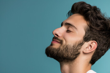 Fototapeta premium A close up of a man with beard and closed eyes looking to a side