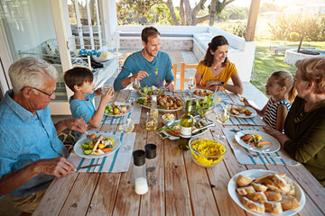 Happy family, eating and lunch with bonding outdoor on patio with conversation, relax or healthy...
