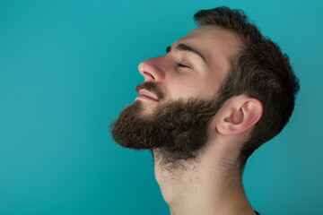 Fototapeta premium A close up of a man with beard and closed eyes looking to a side