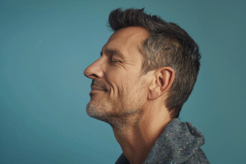 Fototapeta premium A close up of a man with beard and closed eyes looking to a side