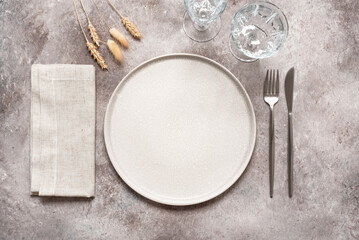 Autumn minimal table setting in beige colors. Top view, flat lay.