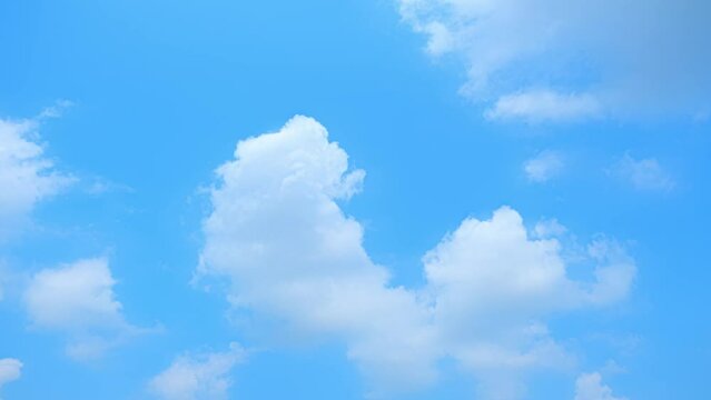 A clouds elegantly glide over a deep blue canvas, transforming the skyline in this stunning 4K time-lapse footage. Weather patterns concept. Video clips. Timelapse. Horizon background. 
